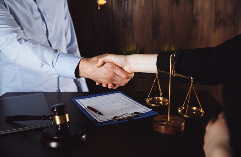 Businessman shaking hands to seal a deal with lawyer