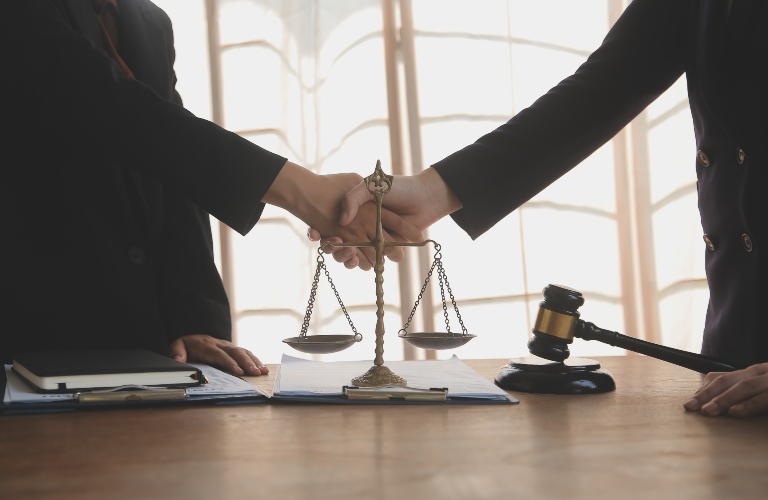 Lawyer shaking hands with a client making about documents